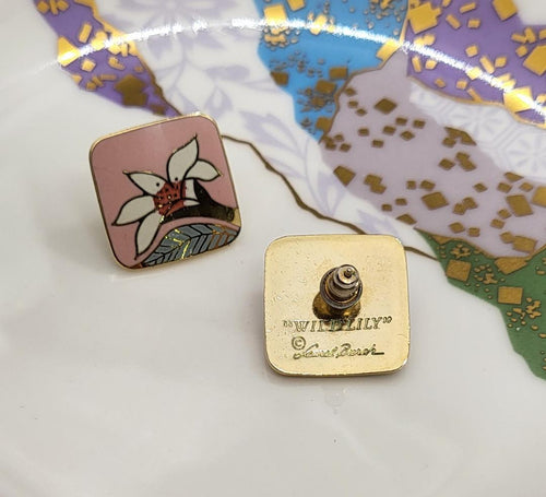 back of earrings show inscribed mark of Laurel Burch and Wild Lily on gold tone surface